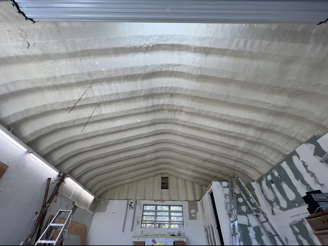 Spray polyurethane foam applied to the underside of a metal roof deck in Benbrook